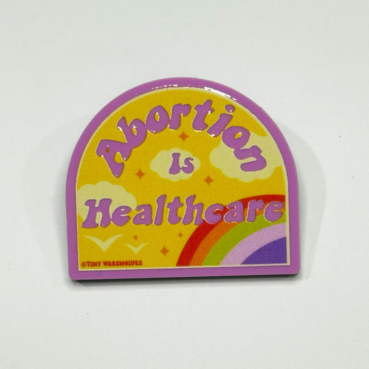 Original artwork by Tiny Werewolves | Abortion is Healthcare Acrylic Pin in Bubblegum Pink | Shop to get your gender neutral Acrylic Pin