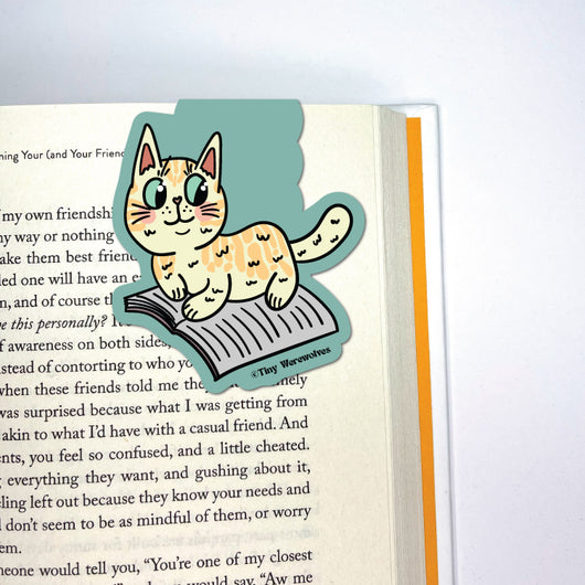 Original artwork by Tiny Werewolves | Orange Book Cat Laminated Magnetic Bookmark in | Shop to get your gender neutral Magnetic Bookmark