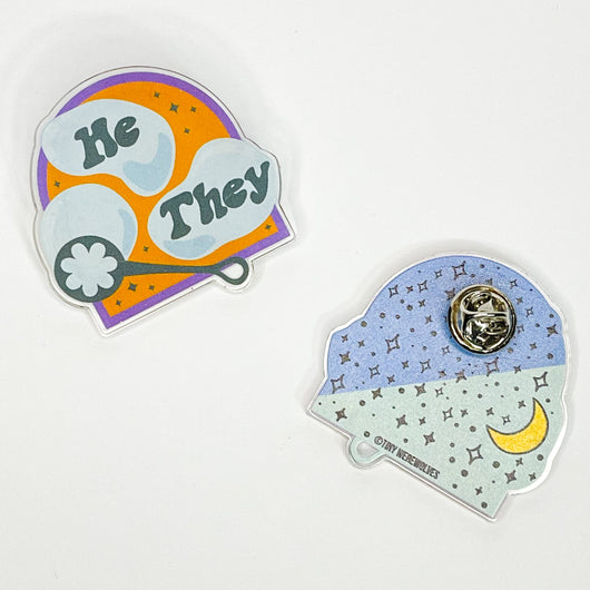 Original artwork by Tiny Werewolves | He / They Pronouns Bubble Acrylic Pin in Clear | Shop to get your gender neutral Acrylic Pin