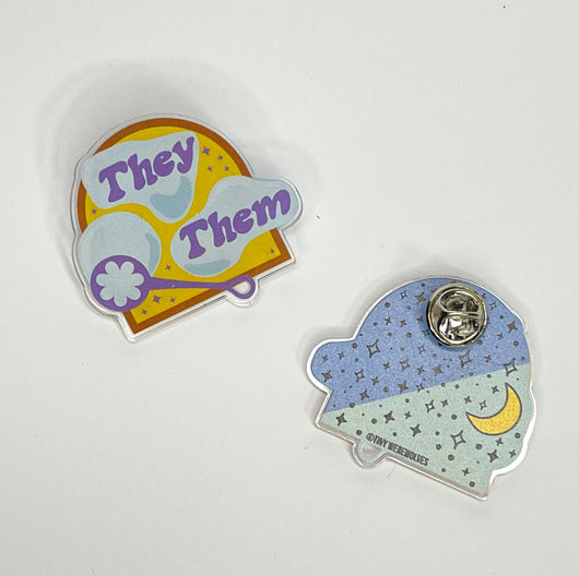 Original artwork by Tiny Werewolves | They / Them Pronouns Bubble Acrylic Pin in Clear | Shop to get your gender neutral Acrylic Pin